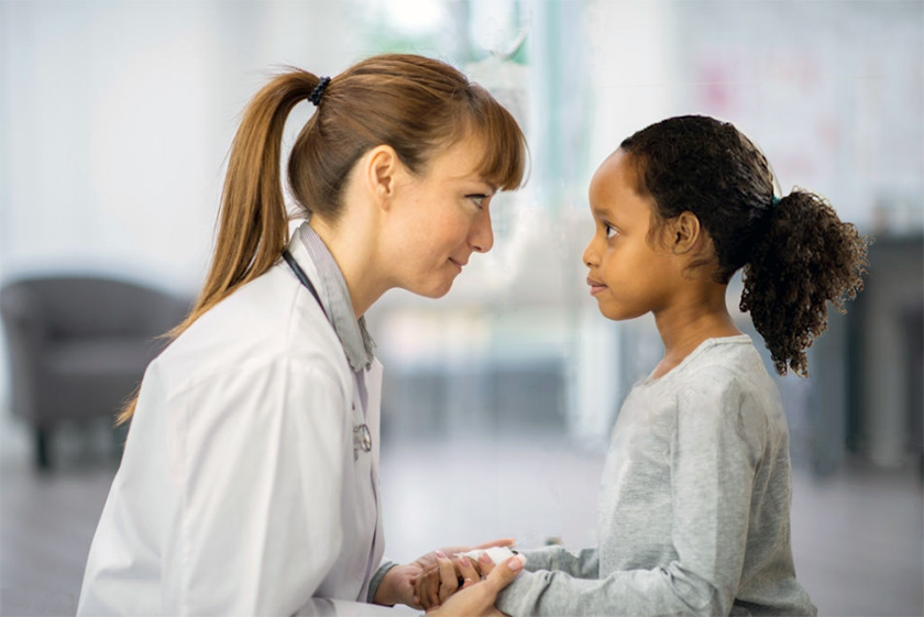 Doctor with young patient, eye-to-eye